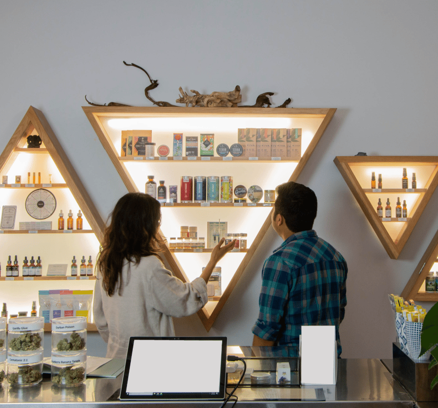 Clean, stylish dispensary interior with wooden shelves and product displays.