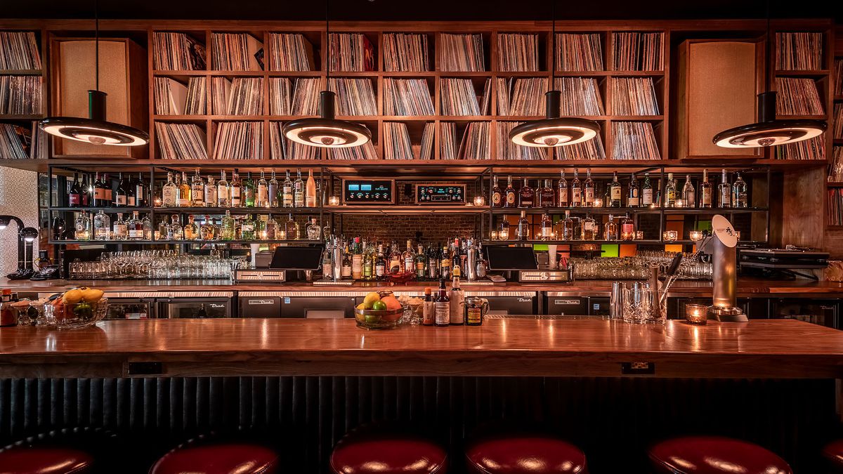 Light rail station platform with signage and overhead canopy in Highland Park.